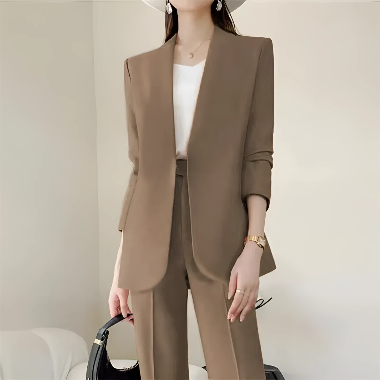 Women's polyester business suit set with blazer and trousers in beige, model standing