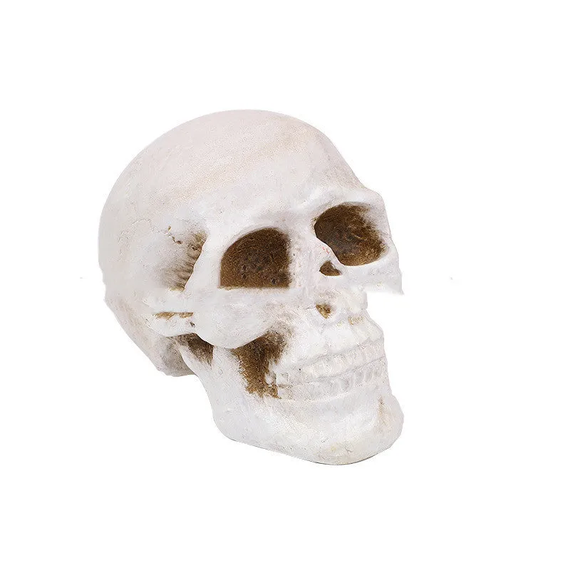 White ceramic skull barbecue model ornament on a flat surface.