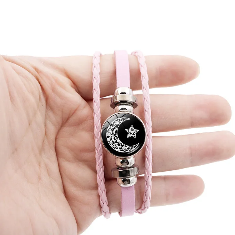 Luminous sun and moon couple leather bracelet on black background, showing glass pattern and adjustable chain