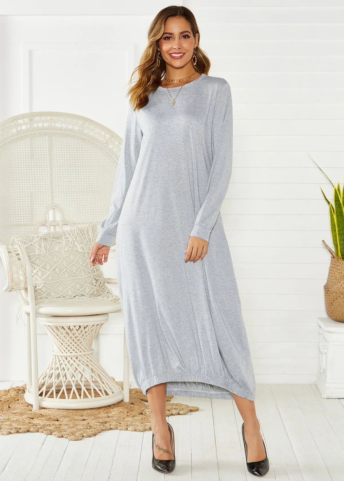 Loose black lantern dress with lace-up crew neck and threads detailing on a mannequin