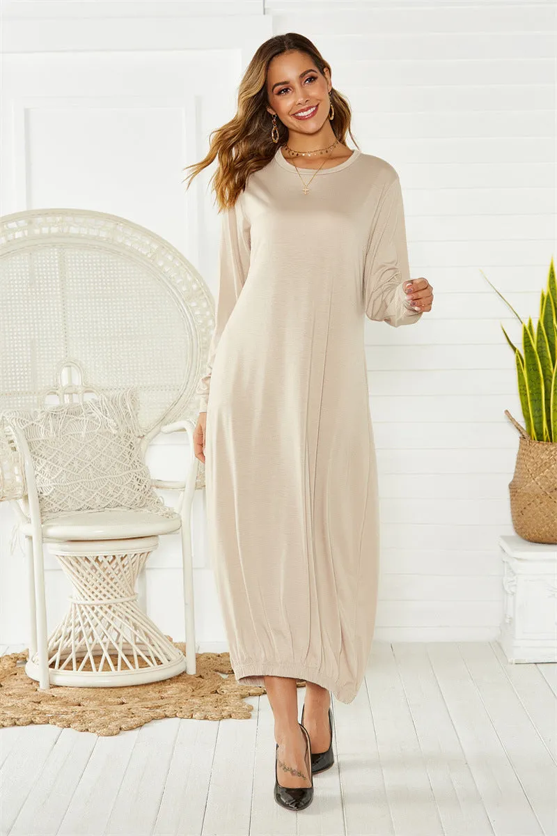 Loose black lantern dress with lace-up crew neck and threads detailing on a mannequin