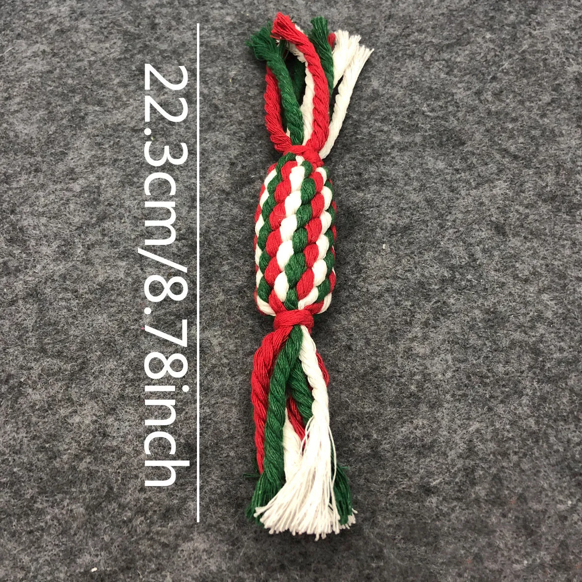 Four Christmas-themed cotton rope dog toys in red and green, including candy cane, bone, crutch, and tree shapes