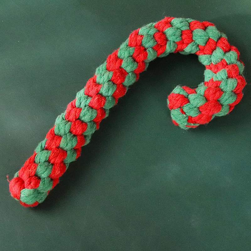 Four Christmas-themed cotton rope dog toys in red and green, including candy cane, bone, crutch, and tree shapes