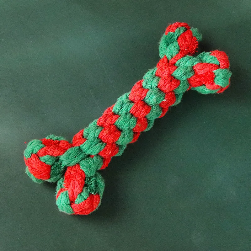 Four Christmas-themed cotton rope dog toys in red and green, including candy cane, bone, crutch, and tree shapes
