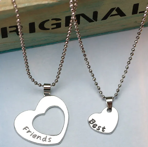 Two silver alloy heart-shaped puzzle necklaces on cross chains, matching set