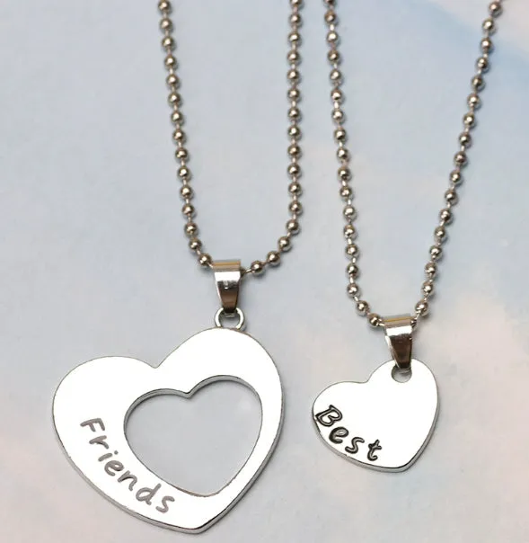 Two silver alloy heart-shaped puzzle necklaces on cross chains, matching set