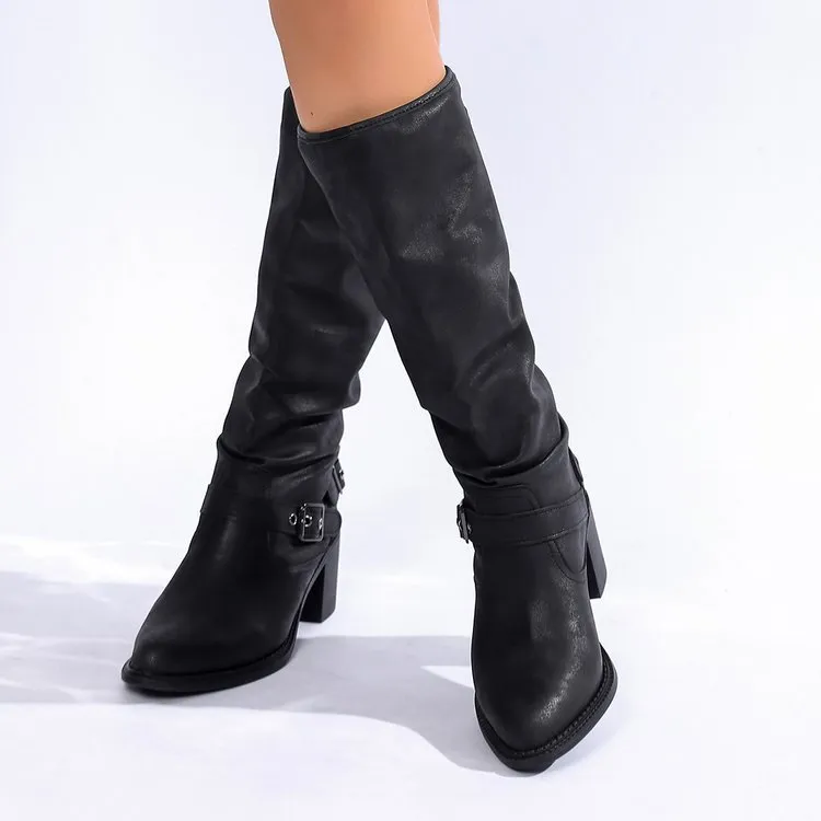 Women's black chunky heel boots with pointed toe and high shaft on display