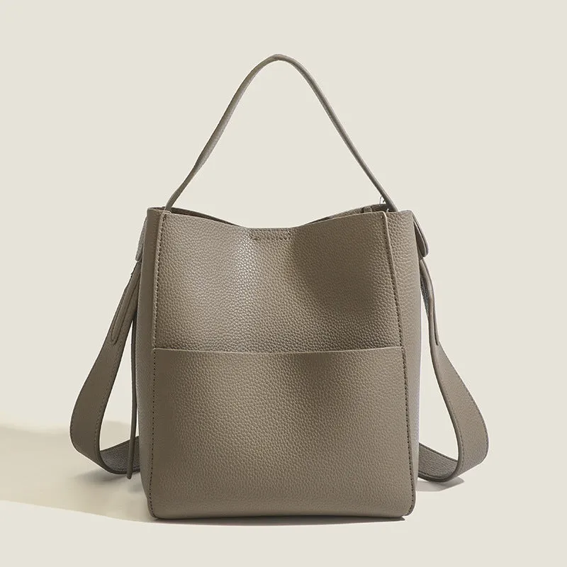 Bucket-style PU messenger bag with sewing line detail, available in black, brown, and elephant gray, on a plain background