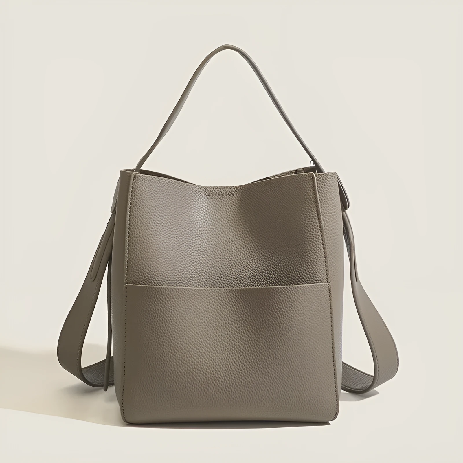 Bucket-style PU messenger bag with sewing line detail, available in black, brown, and elephant gray, on a plain background