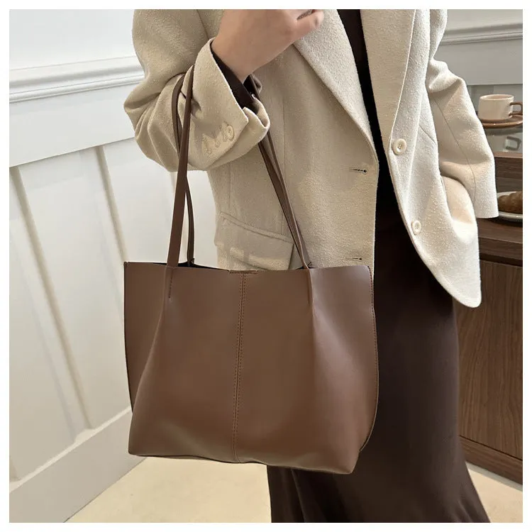 Casual messenger bag in PU leather with stitched detail, bucket shape, double shoulder straps, available in black brown coffee white