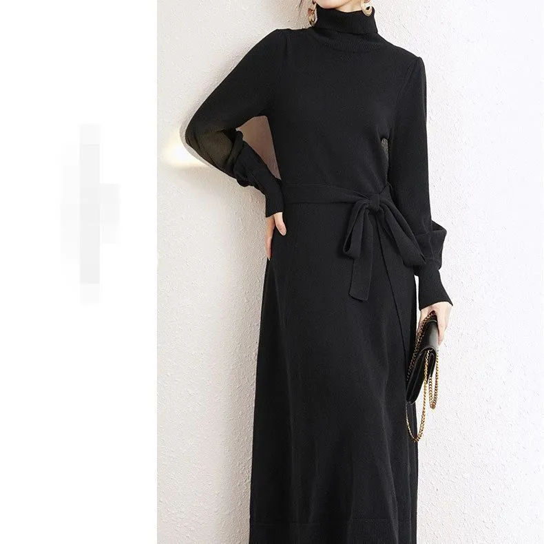 Rose red loose turtleneck knit dress with long sleeves and a flared skirt hem on a hanger.