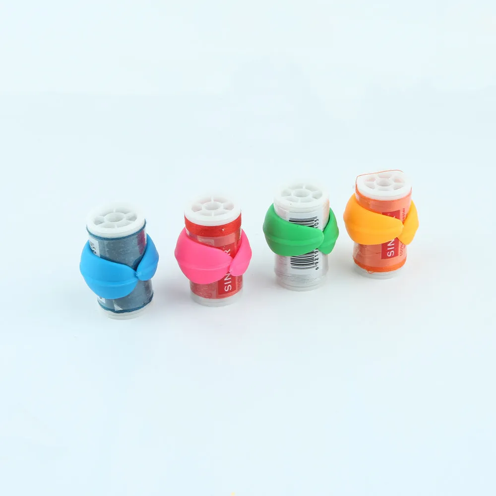 14 silicone sewing spool fixed clips in red, blue, orange, and green on a white background