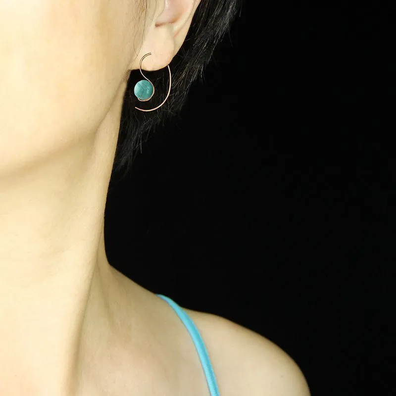Green turquoise retro style dangle earrings with blue turquoise centrepiece on a white background