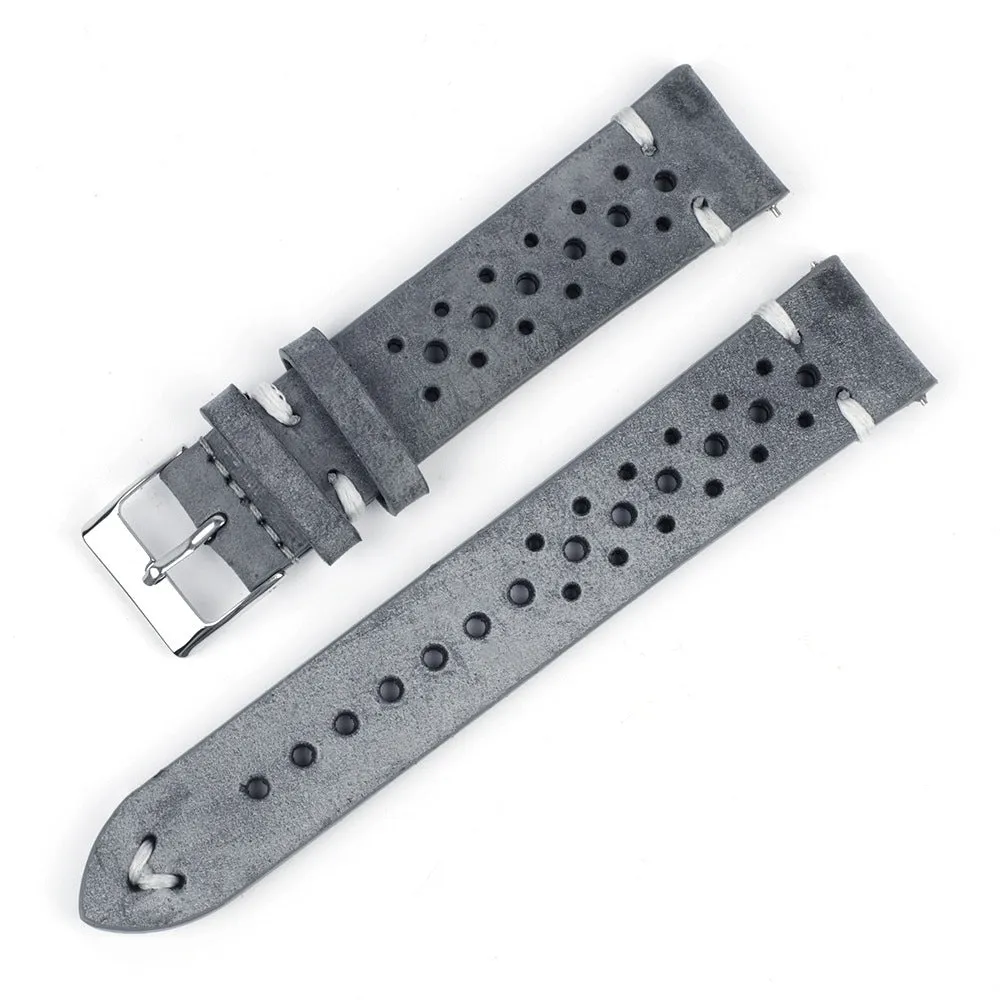 Handmade retro genuine leather watch band in brown with white stitching on a wooden surface