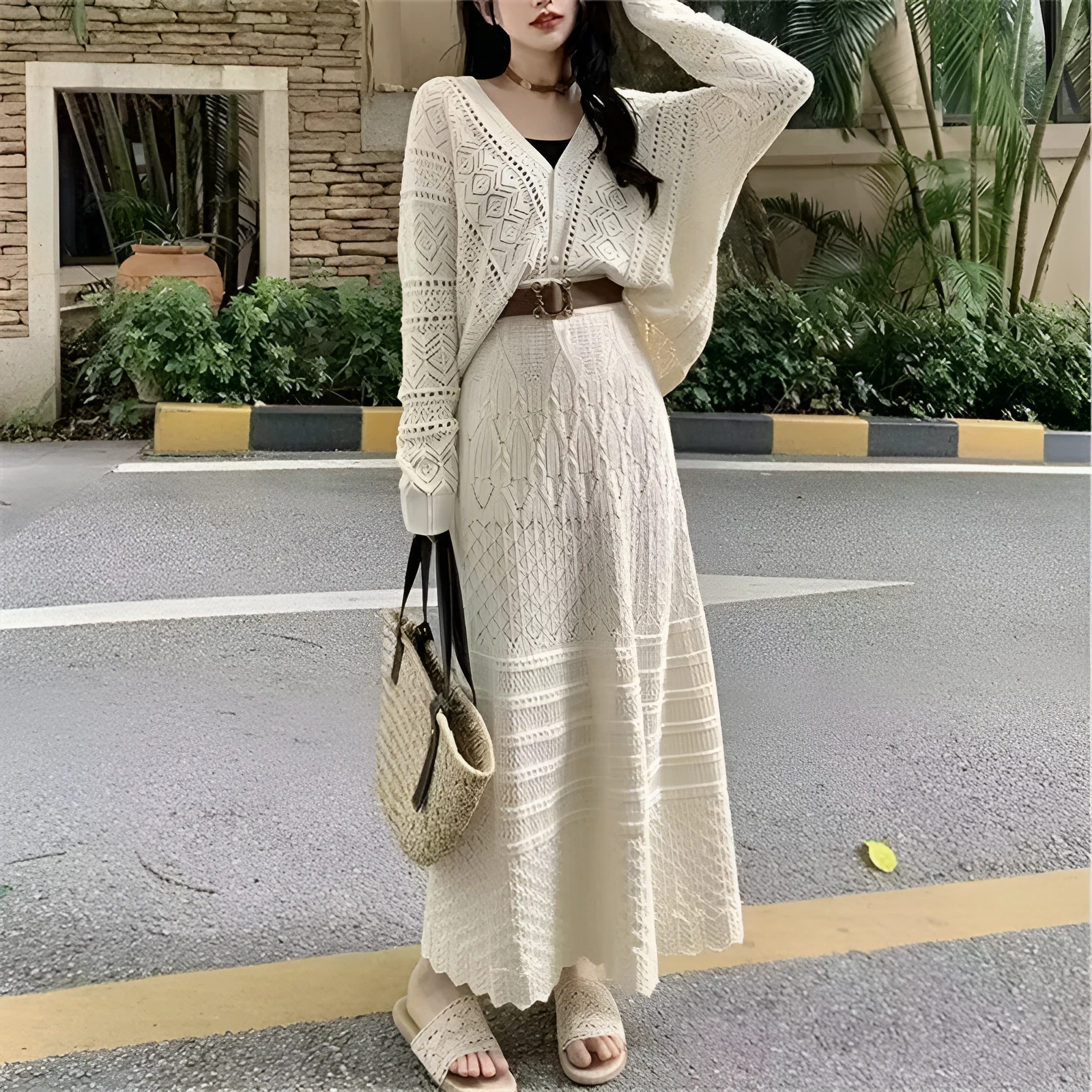 Beige two-piece set with hollowed-out knit top and mid-length lace-up skirt and belt