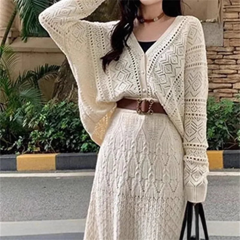 Beige two-piece set with hollowed-out knit top and mid-length lace-up skirt and belt
