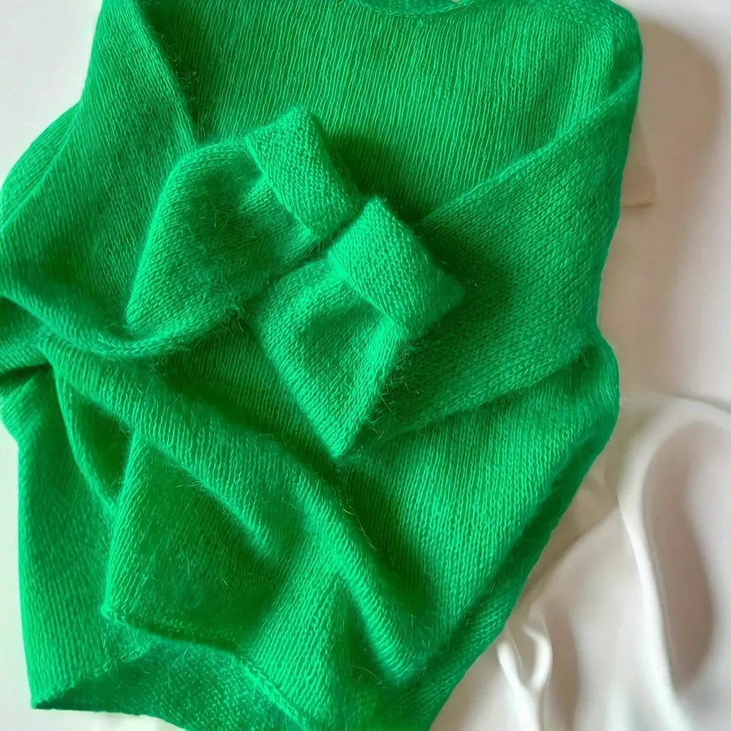 Green crew neck loose fit long sleeve polyester pullover sweater for women on plain background