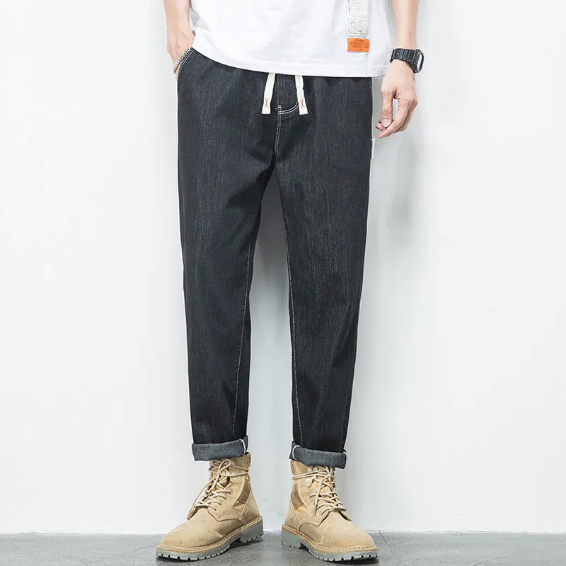 Men's loose plus size elastic waist jeans in blue cotton denim with mid waist straight leg fit