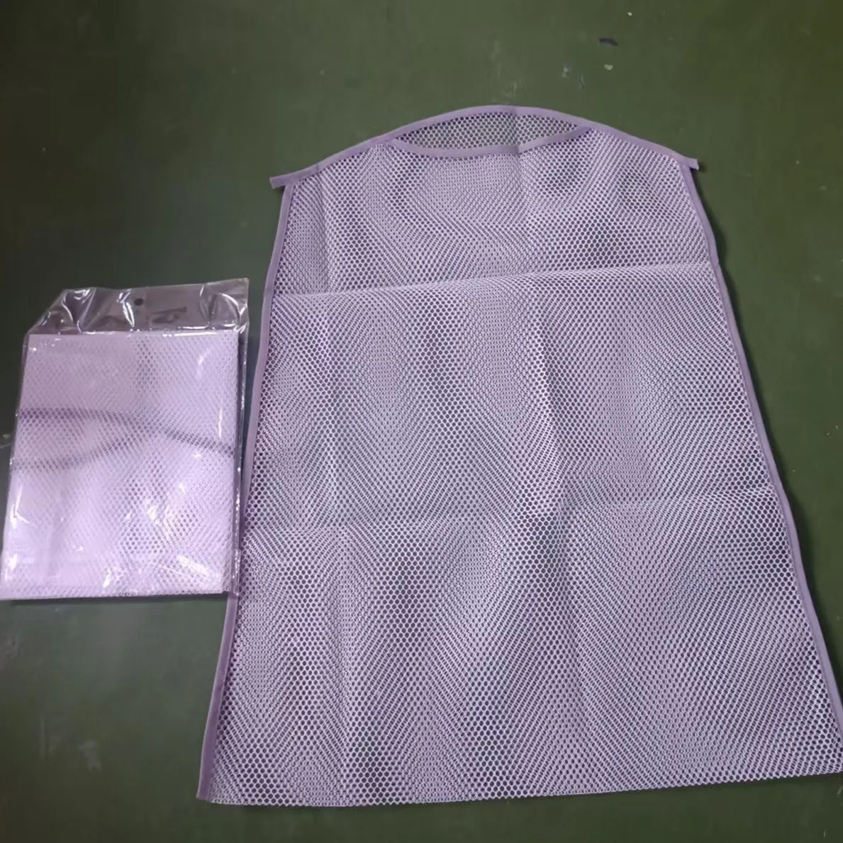 White fabric mesh pillow drying hanger with net pocket on a clothesline outdoors