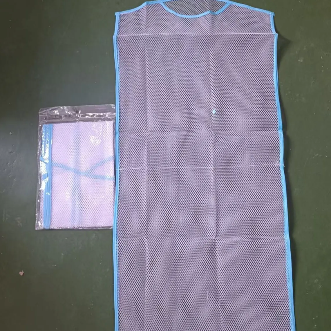 White fabric mesh pillow drying hanger with net pocket on a clothesline outdoors