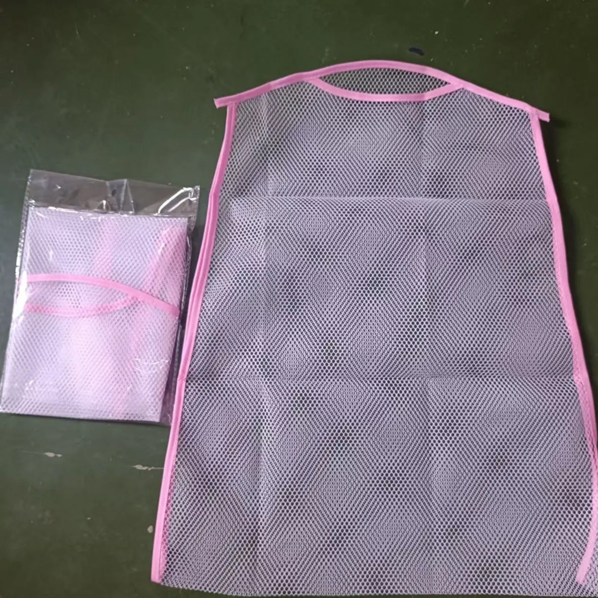 White fabric mesh pillow drying hanger with net pocket on a clothesline outdoors