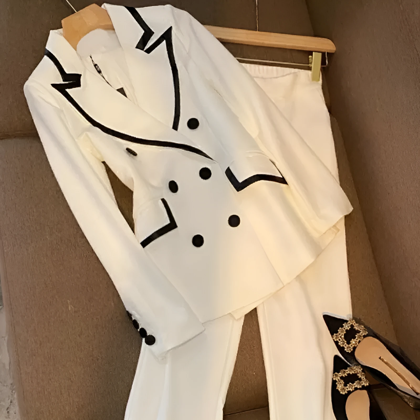 White polyester women's formal suit set with blazer top and matching trousers