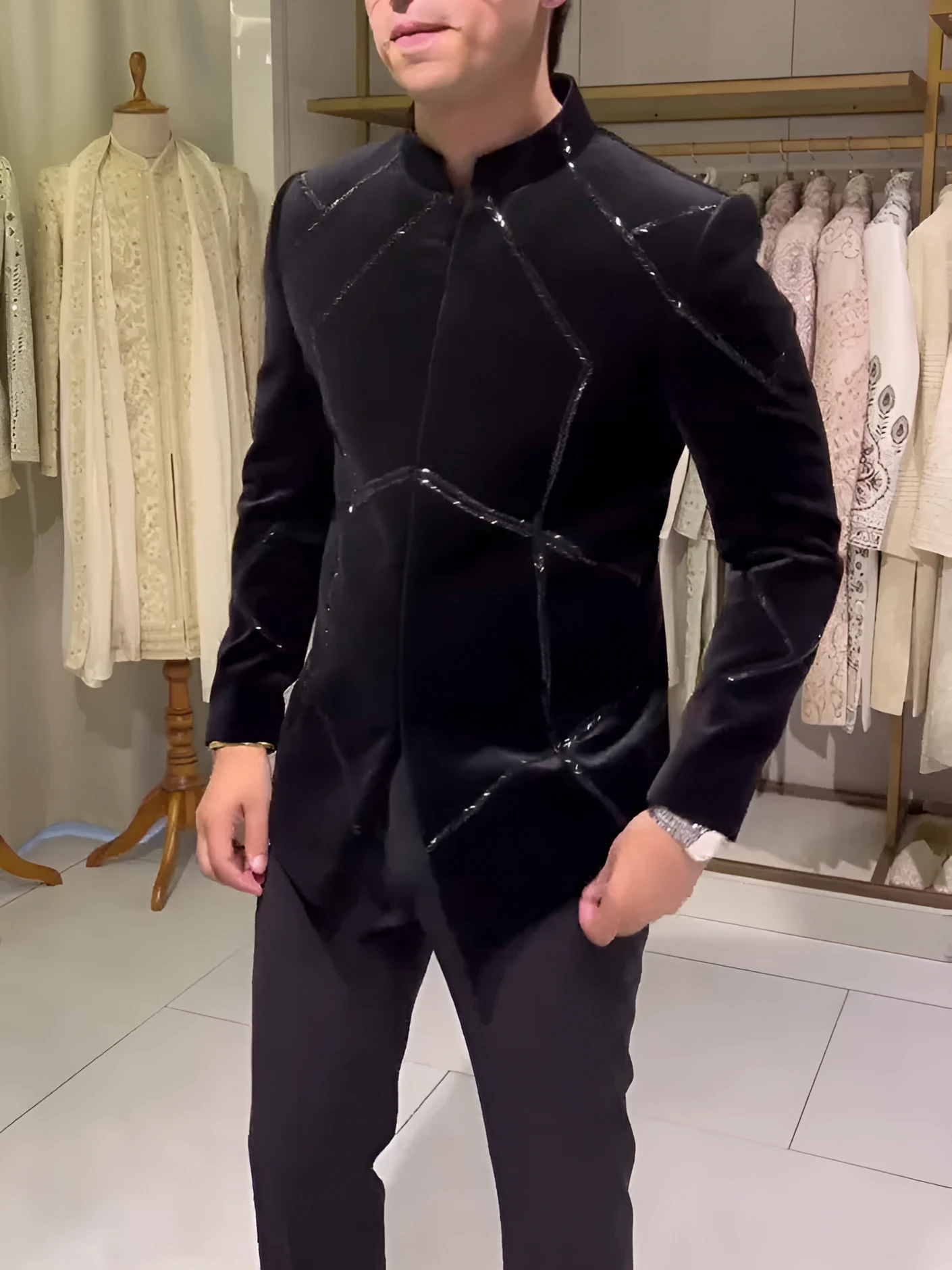 Black structured jacket with contrast geometric patchwork accents, regular fit, front view