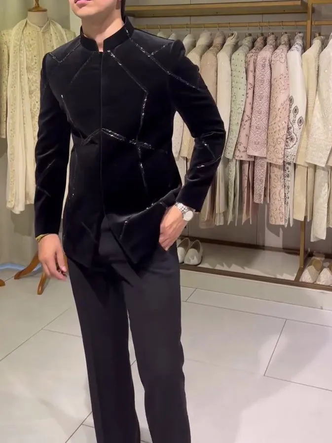 Black structured jacket with contrast geometric patchwork accents, regular fit, front view