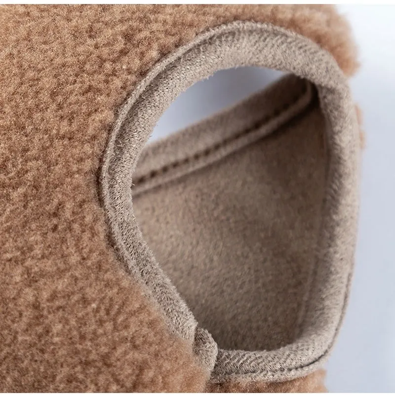 Brown fleece dog coat with bear embroidery and side-button closure on a small dog