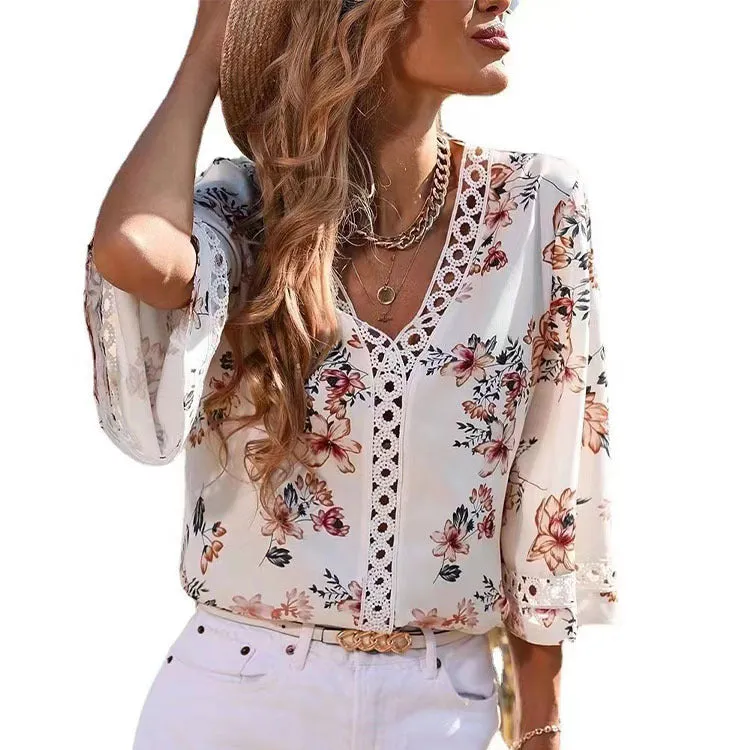 Loose V-neck pullover top with bell sleeves, lace trim, and printed pattern in white