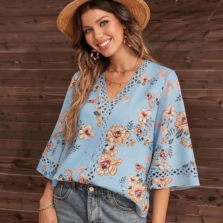 Loose V-neck pullover top with bell sleeves, lace trim, and printed pattern in white