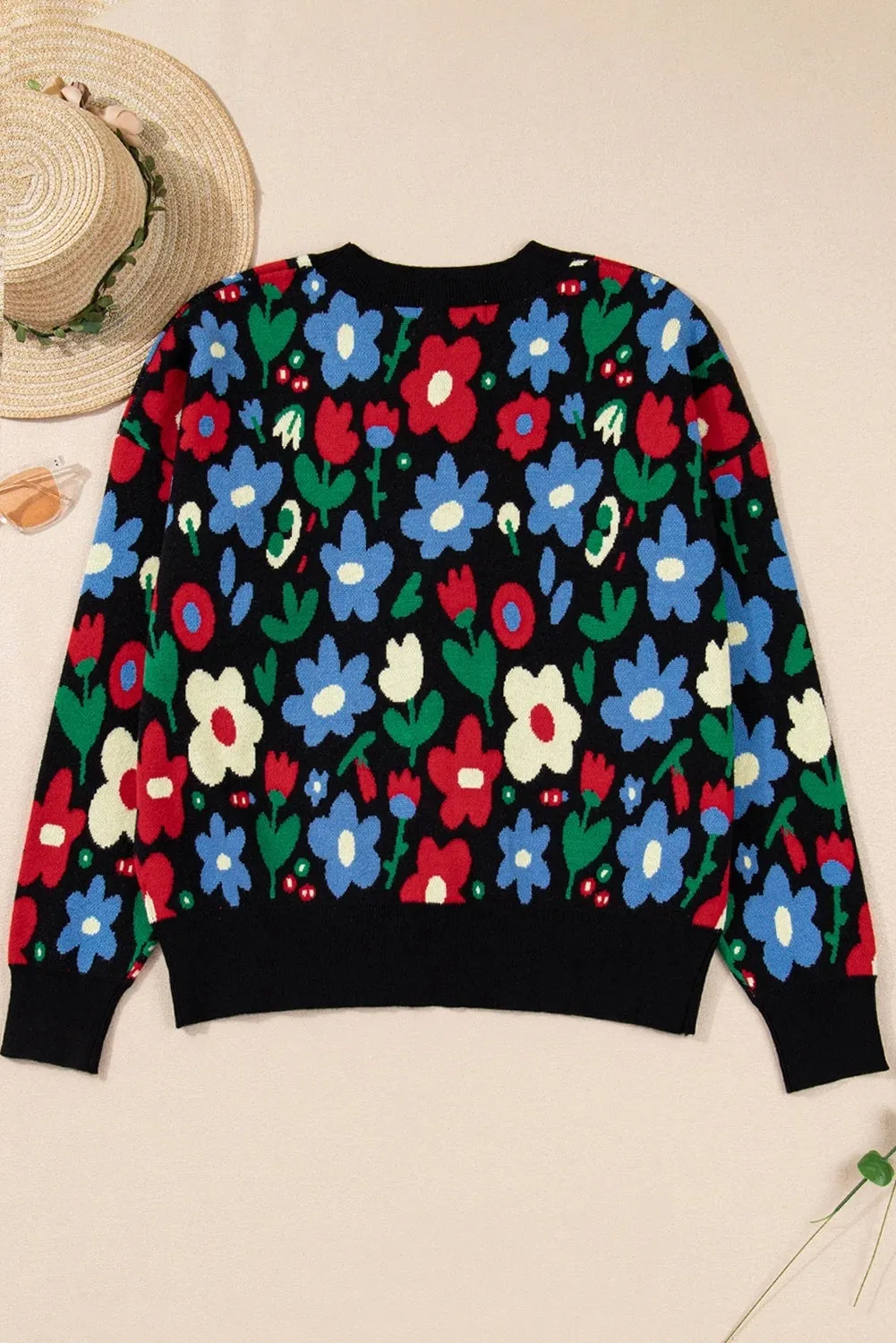 Black floral print V-neck button short cardigan sweater on model, long sleeves, shift silhouette