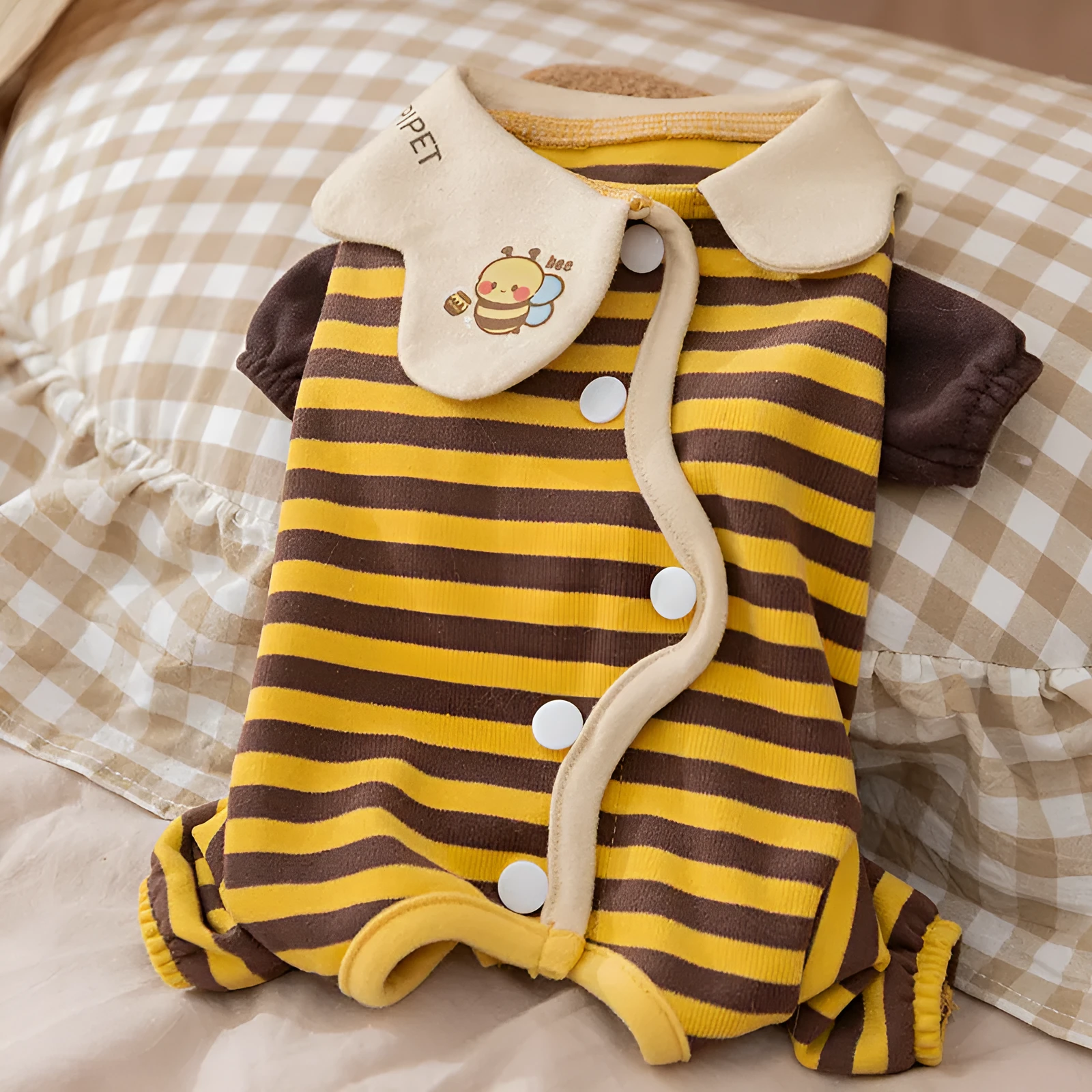 Dog pajama suit with yellowish-brown bee pattern on stripes, four-legged design, and lapel collar for small pets