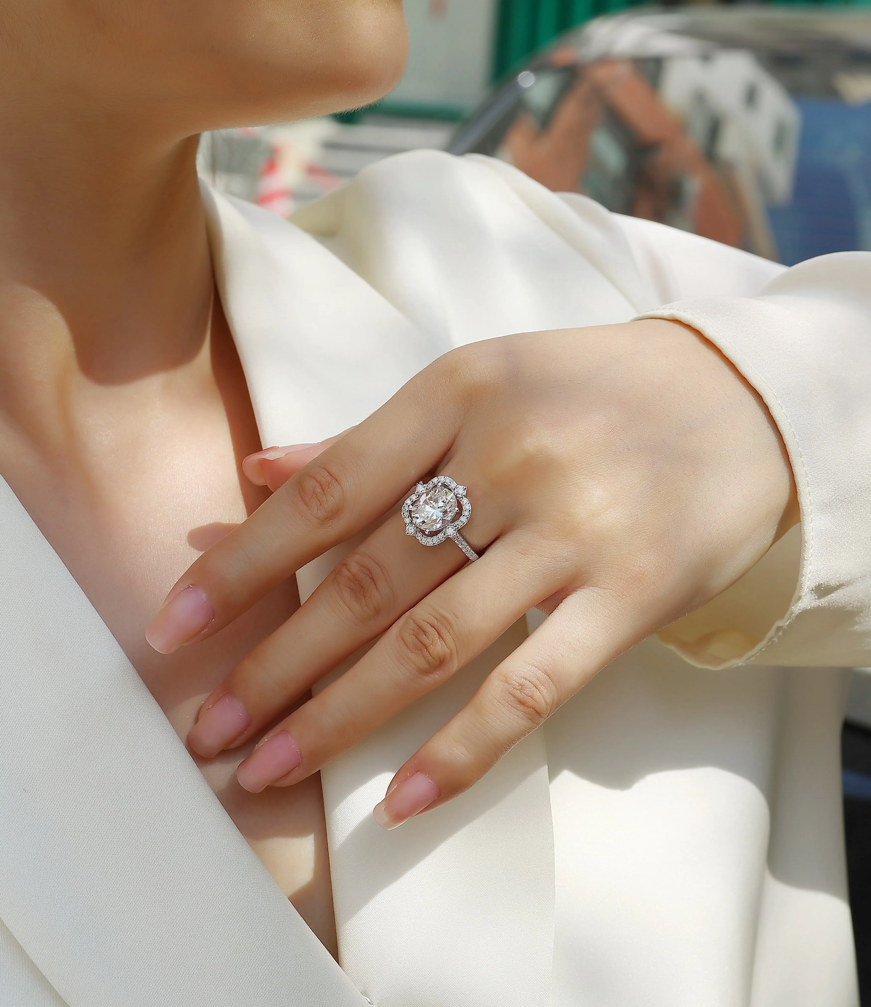 Egg-shaped moissanite ring set with S925 silver and platinum plating on a white surface