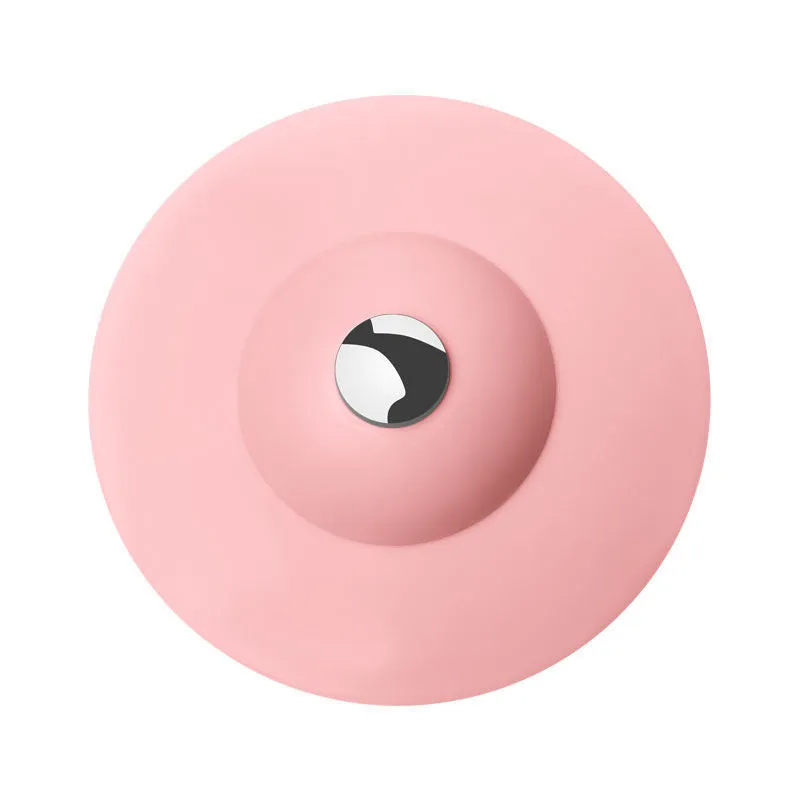 UFO-style silicone press sink drain cover in blue on a white basin, modern minimalist design