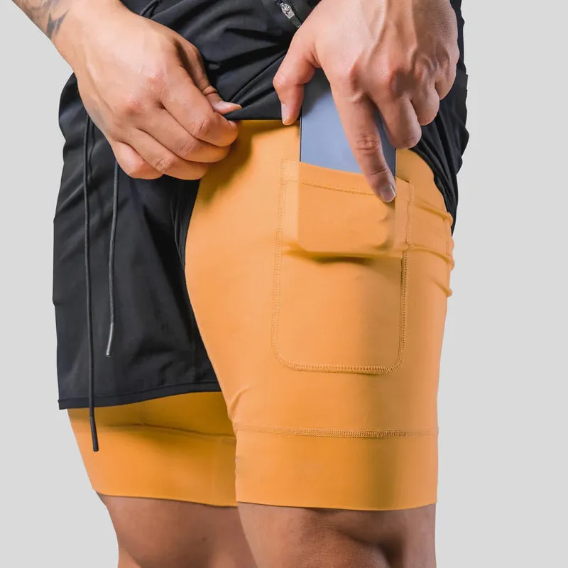 Men's double layer running shorts in light slate green and black, with built-in lining and mid-rise waist for fitness use
