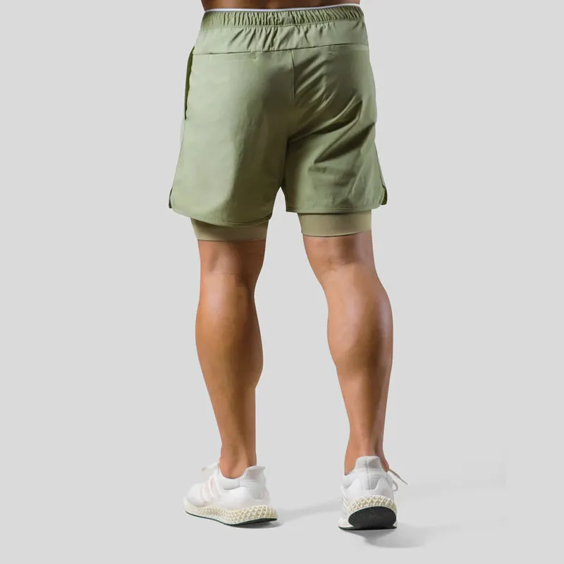 Men's double layer running shorts in light slate green and black, with built-in lining and mid-rise waist for fitness use