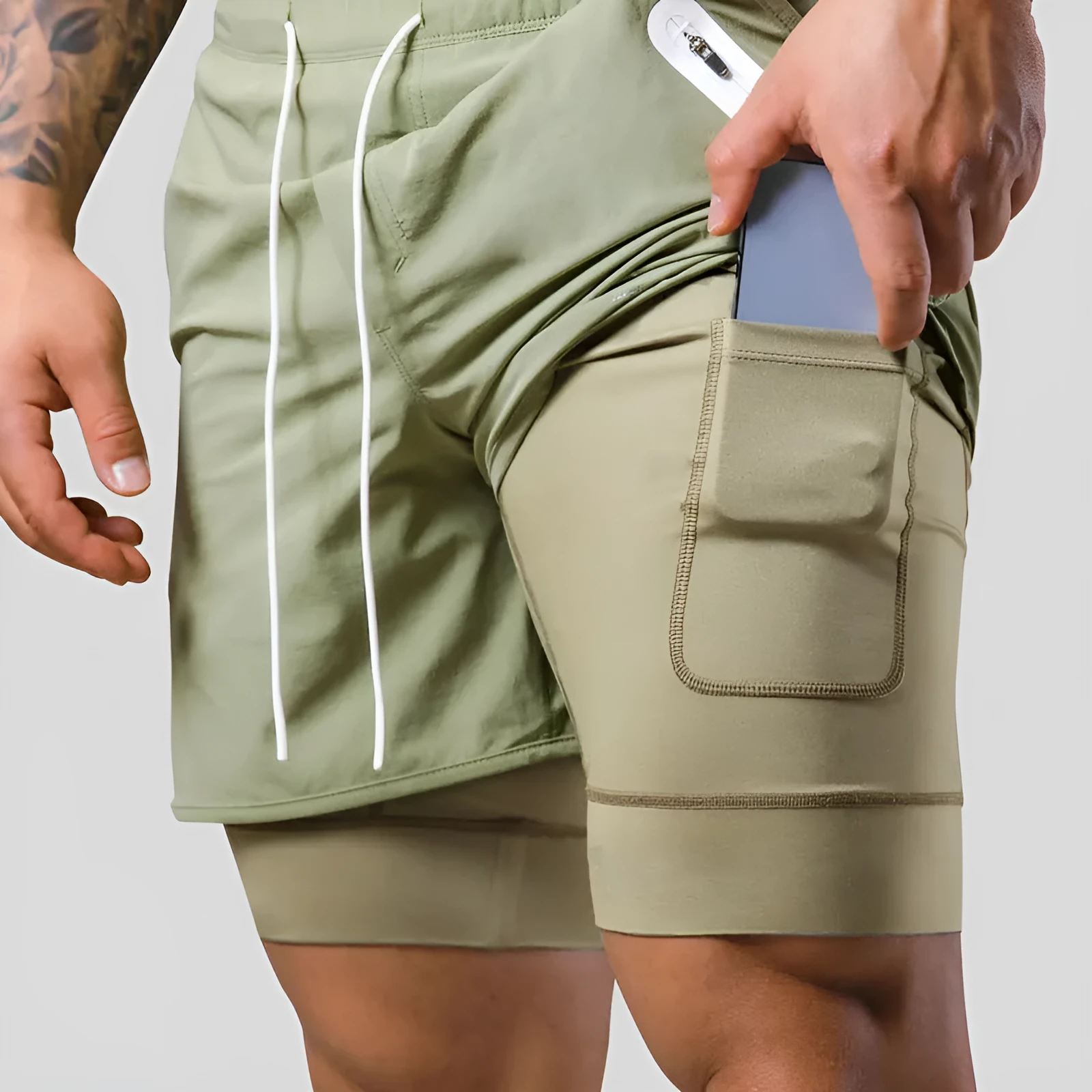 Men's double layer running shorts in light slate green and black, with built-in lining and mid-rise waist for fitness use