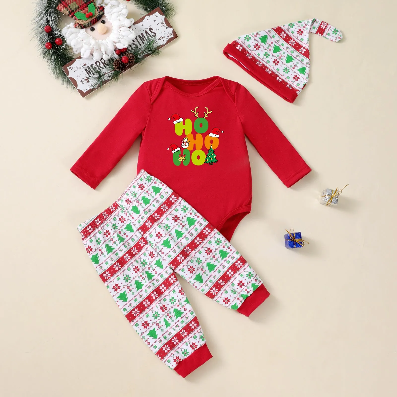 Baby Christmas tree print long-sleeve bodysuit, pants, and hat three-piece outfit on a white background