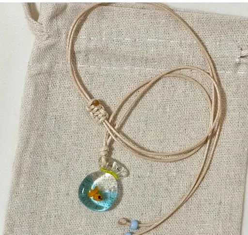 Women's joker pendant necklace with coloured glaze charm on a cotton and linen clavicle chain.