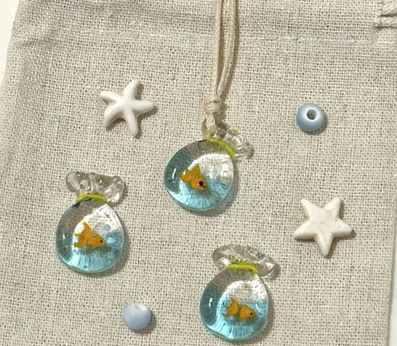 Women's joker pendant necklace with coloured glaze charm on a cotton and linen clavicle chain.