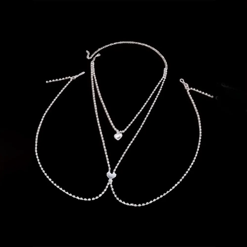 Gold or silver coloured heart-shaped body chain for women with rhinestone detailing.