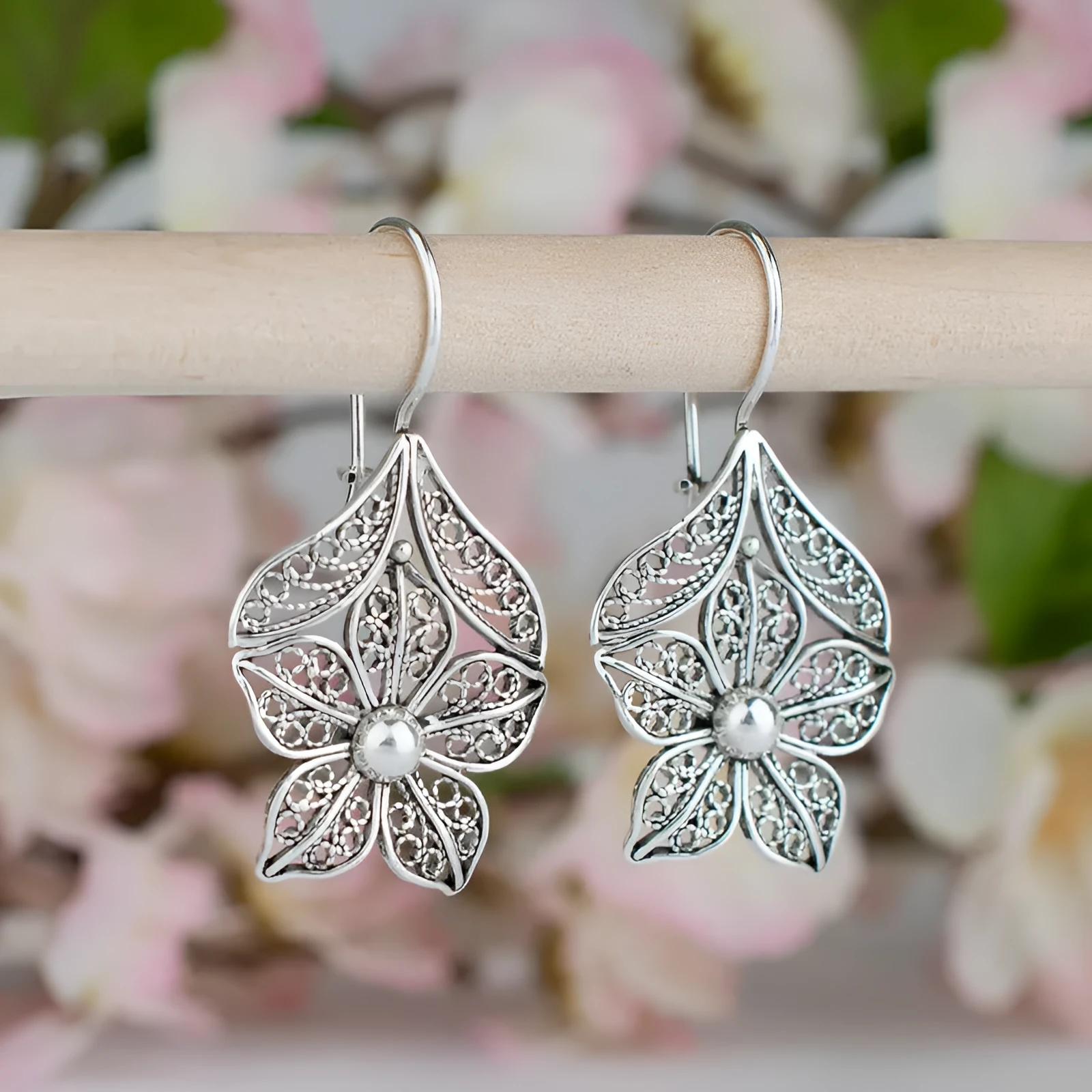 Silver alloy hollow flower leaf-shaped women's earrings with retro floral metal design