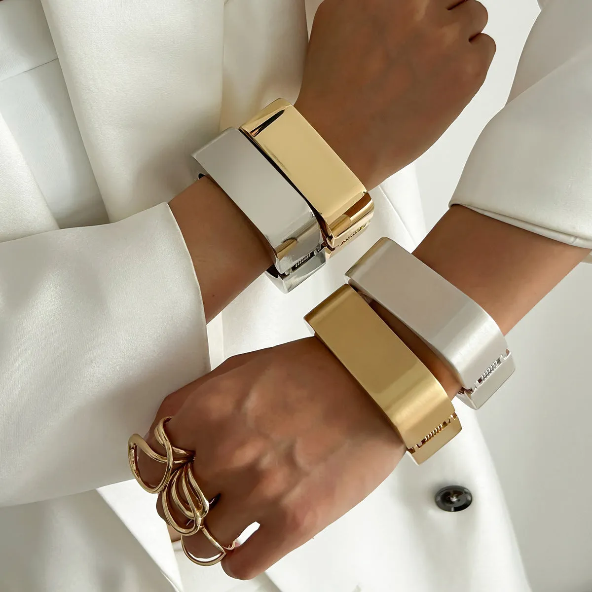 Metal texture glossy spring bracelet with geometric square mirror design in gold colour on white background