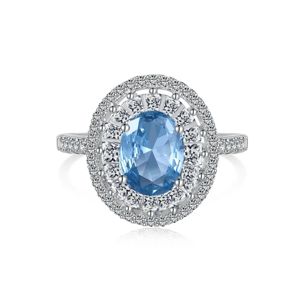 Women's S925 sterling silver ring with sea blue zircon heart or bow shape on plain background