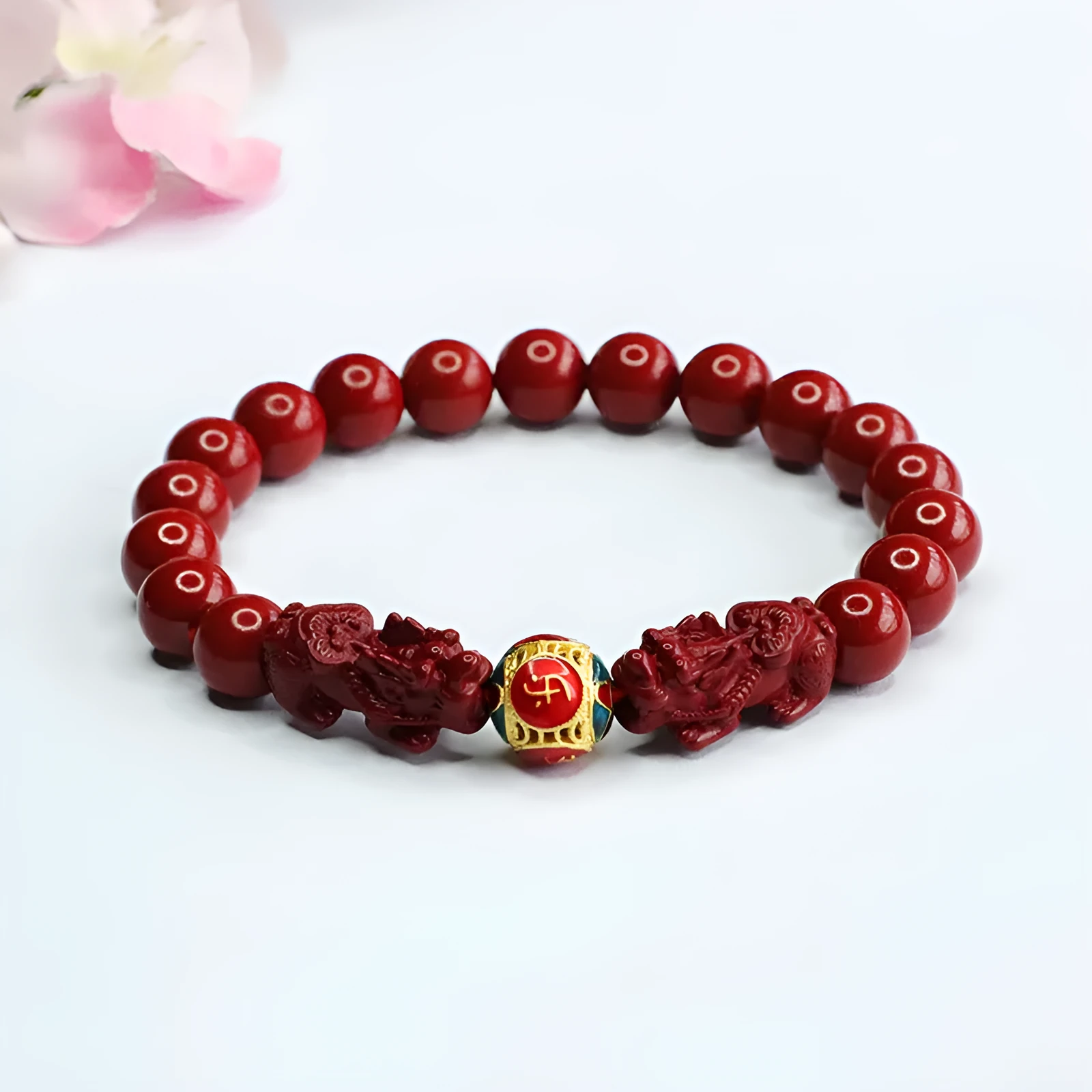 Close-up of a purple gold sand Cinnabar bracelet with carved Double Pixiu design, bead size 8mm.