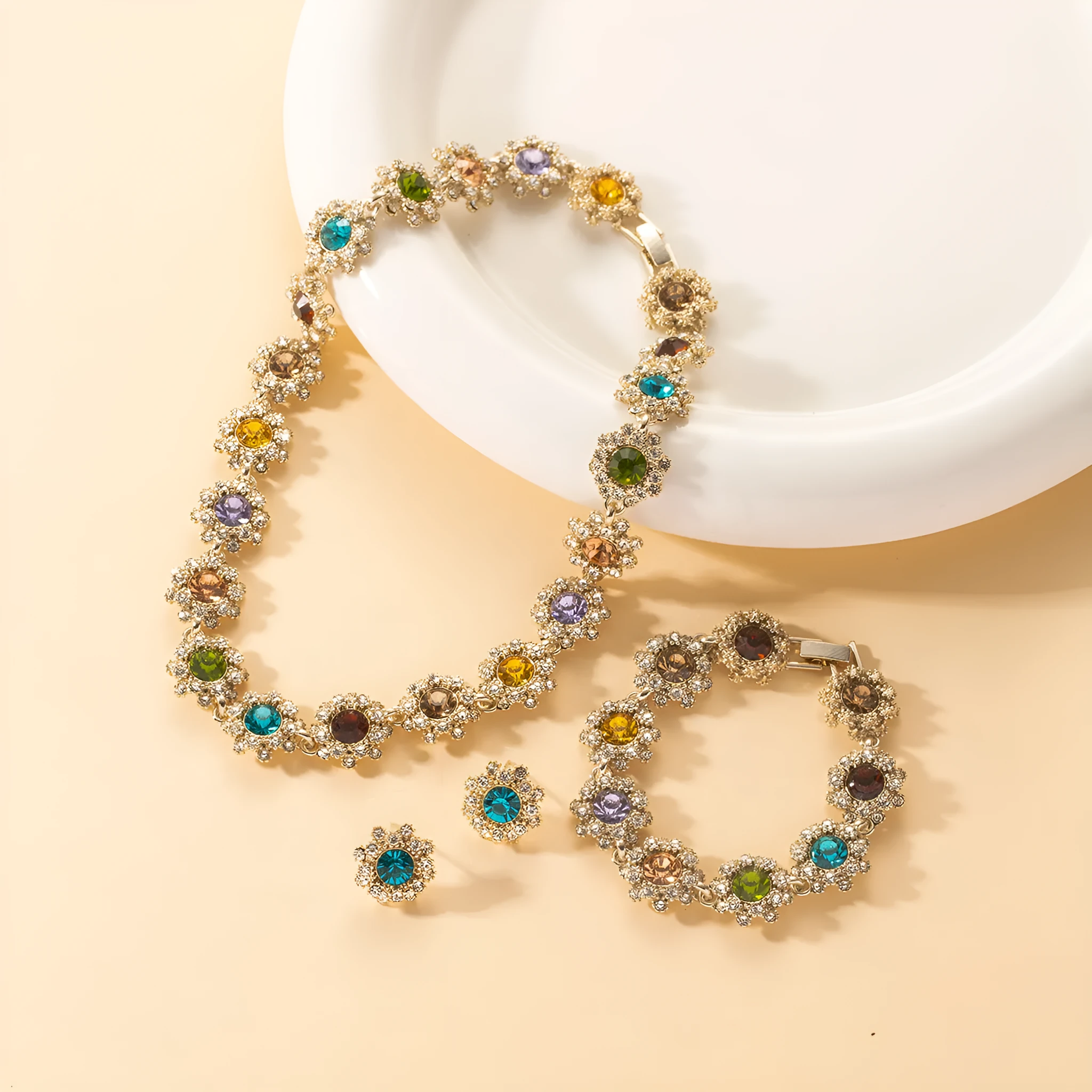 Colorful rhinestone necklace, earrings, and bracelet set on display, electroplated zinc alloy, geometric pendant