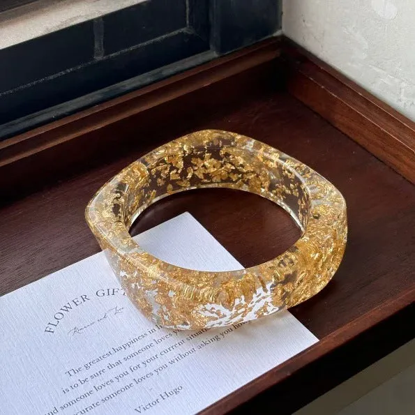 Geometric blooming resin curved bracelet in diamond transparent purple with polished finish