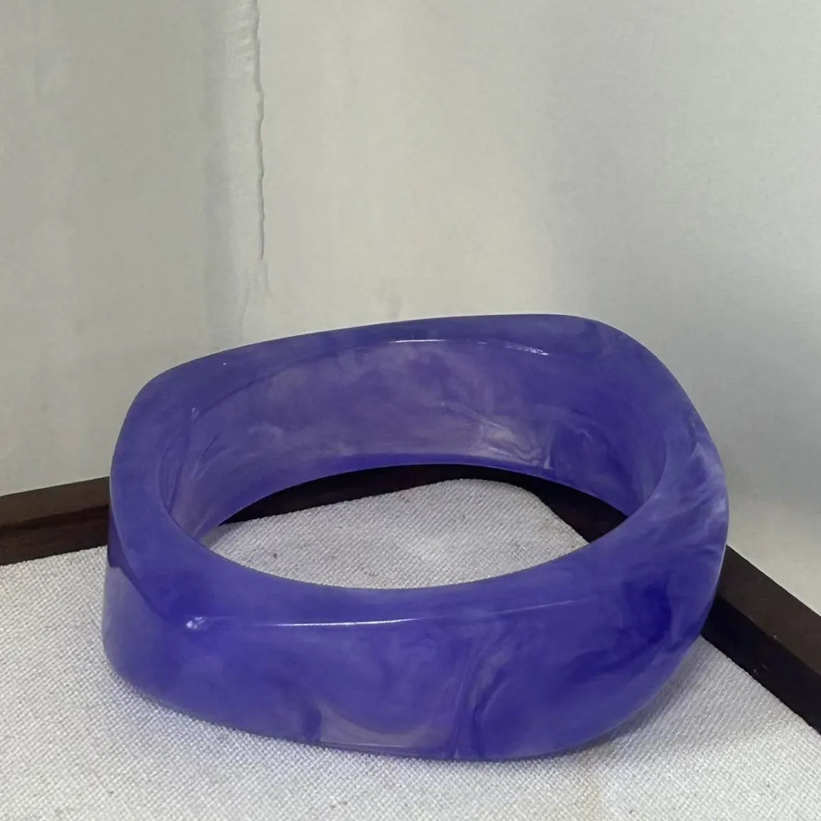 Geometric blooming resin curved bracelet in diamond transparent purple with polished finish