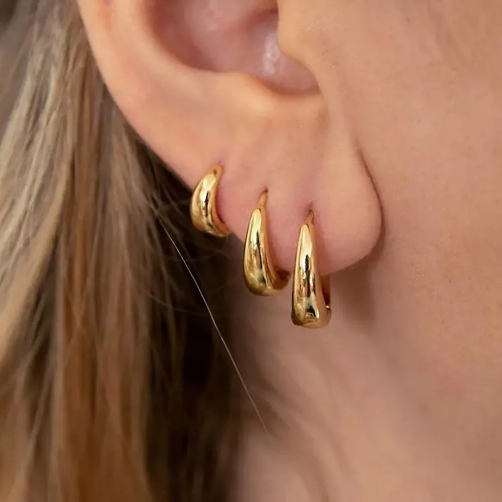 Geometric copper earring set of 3 glossy gold electroplated round shape earrings on display